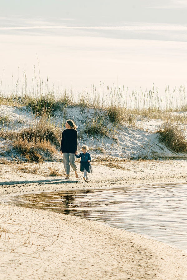 mother and child walking on a dune lake in Dune Allen Beach