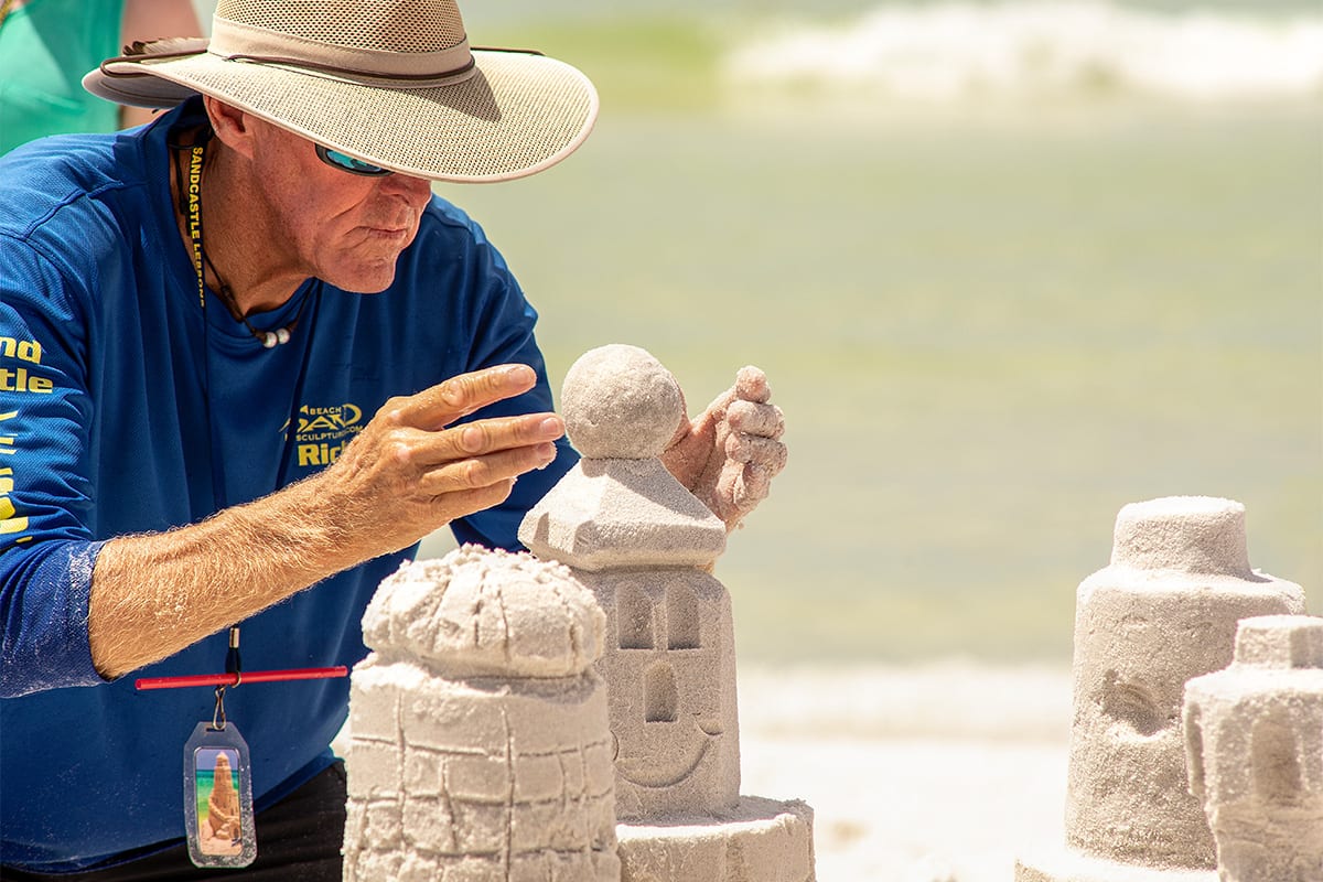 man building sandcastle