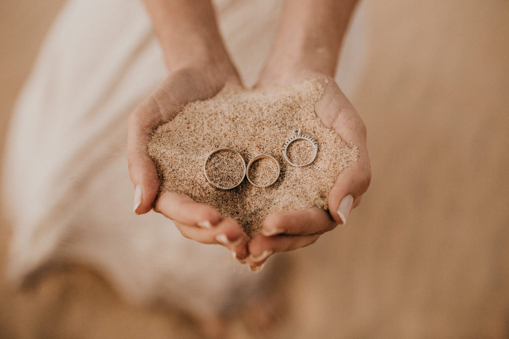 wedding rings in sand