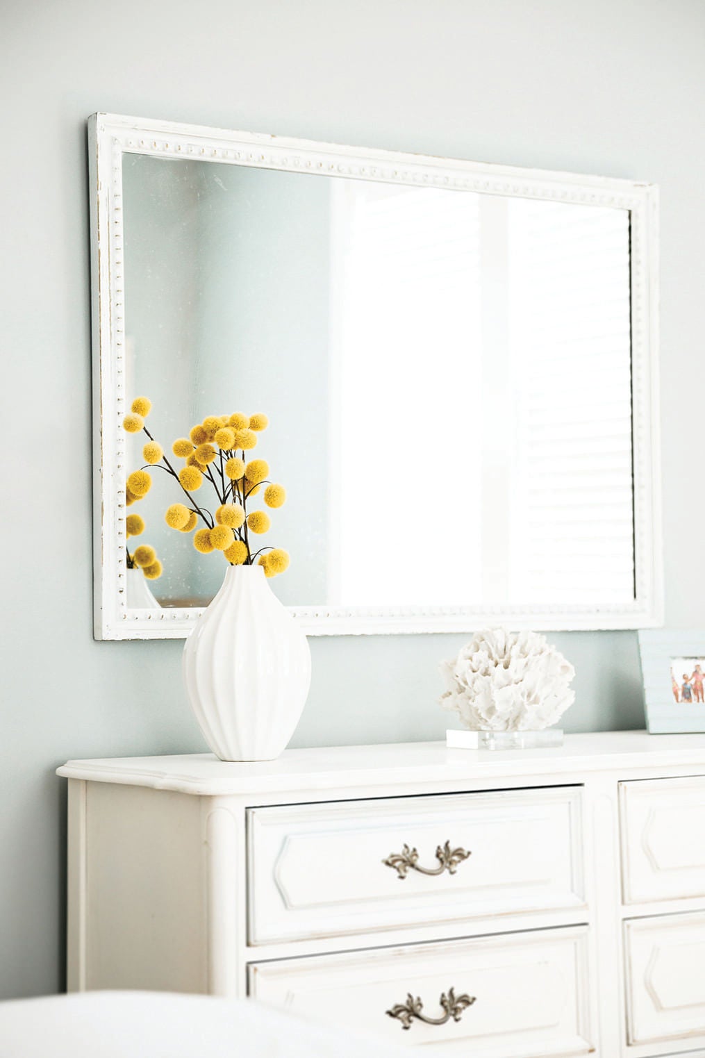 dresser in befroom with yellow flowers