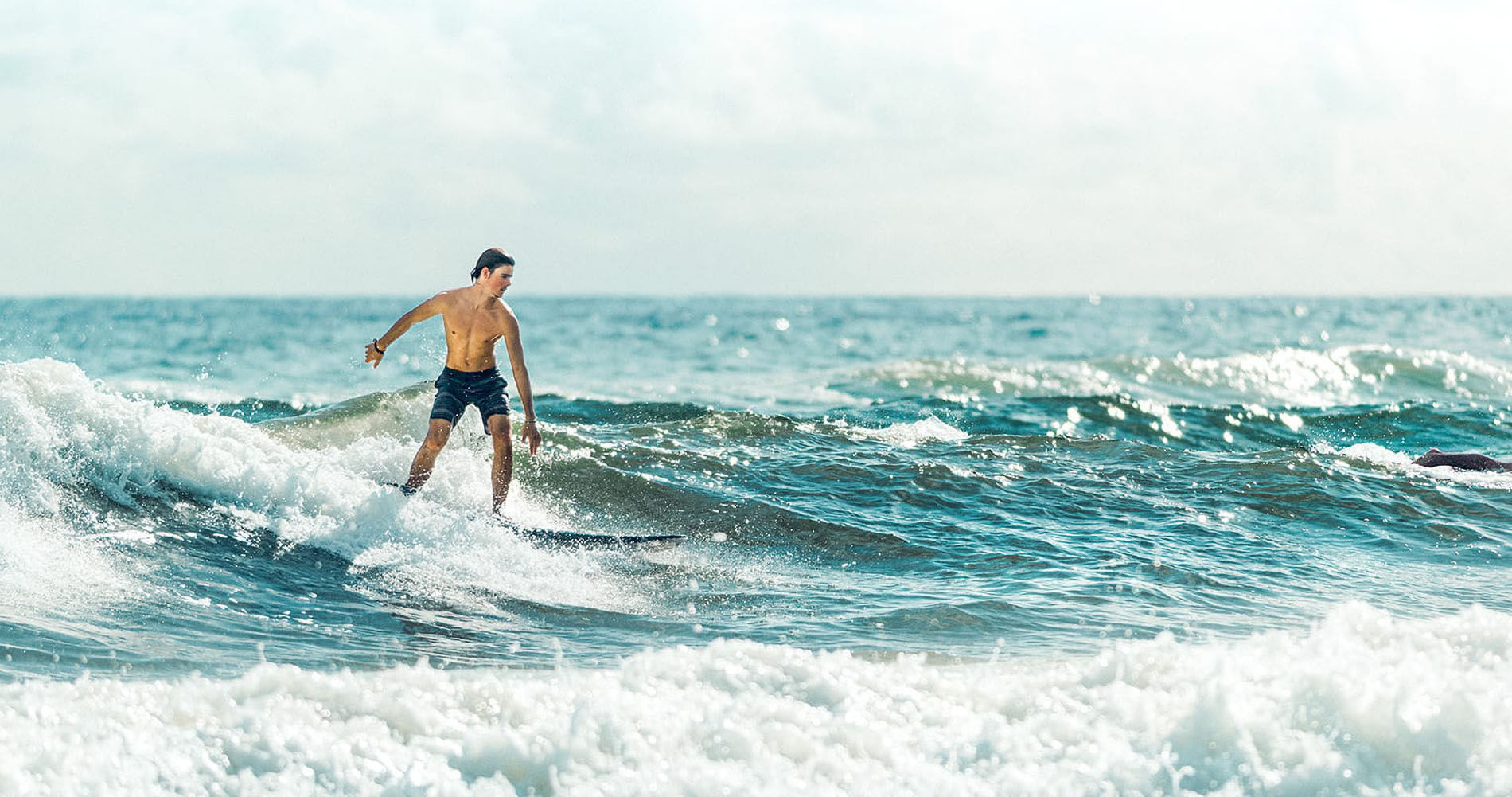 boy surfing in the gulf