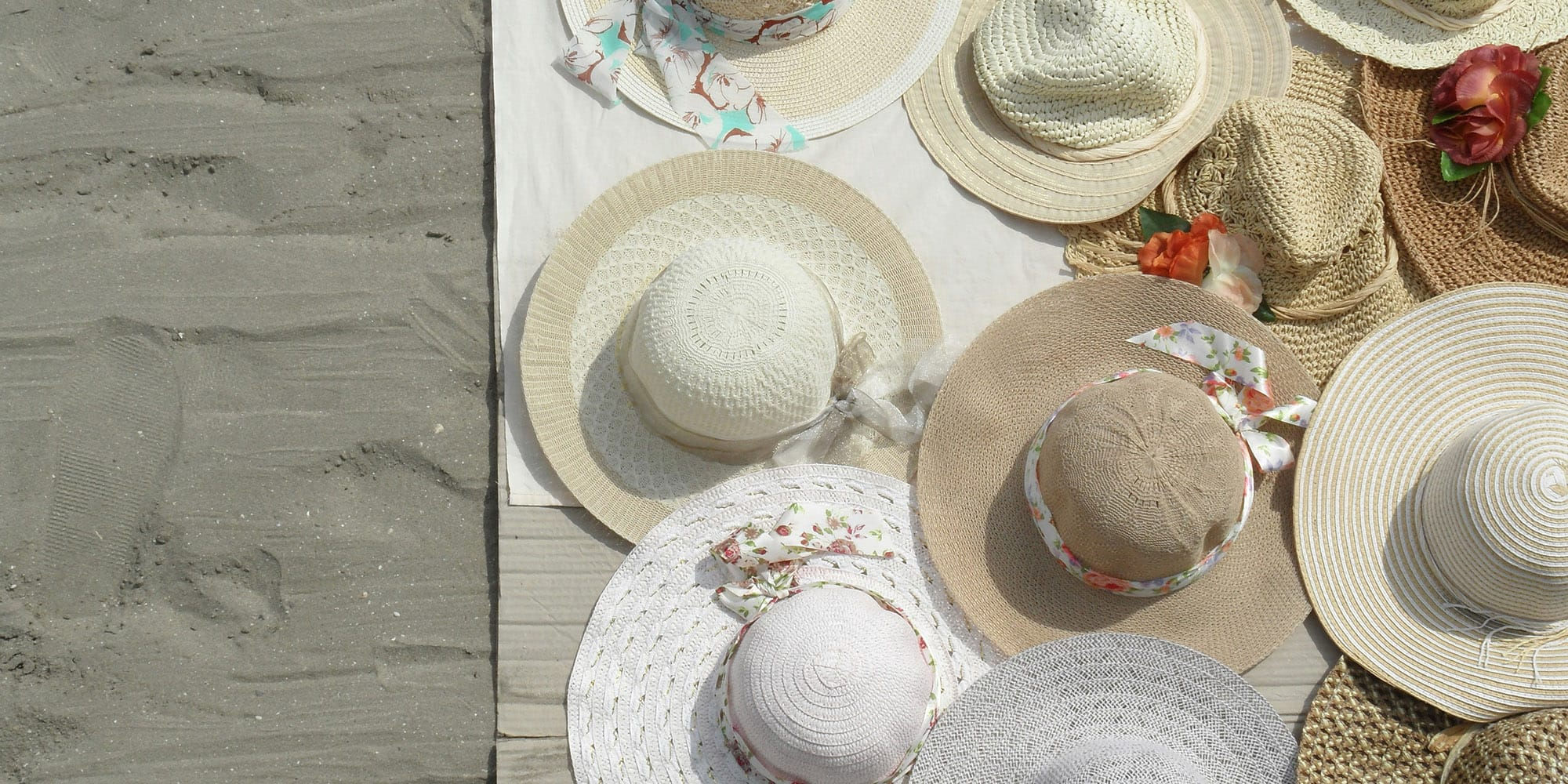 Hats on towl in the sand